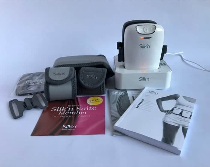The contents of the Silk'n Lipo fat reduction belts: EMS electrode pads, 3 different sized Velcro body belts and laser pad connectors, 2 diode laser pads in their charging cradle, warranty and user guide booklet, support membership card.